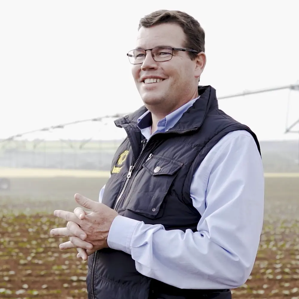 Thomas Serrarens standing in his field in Sao Paulo in front of his pivot irrigation system